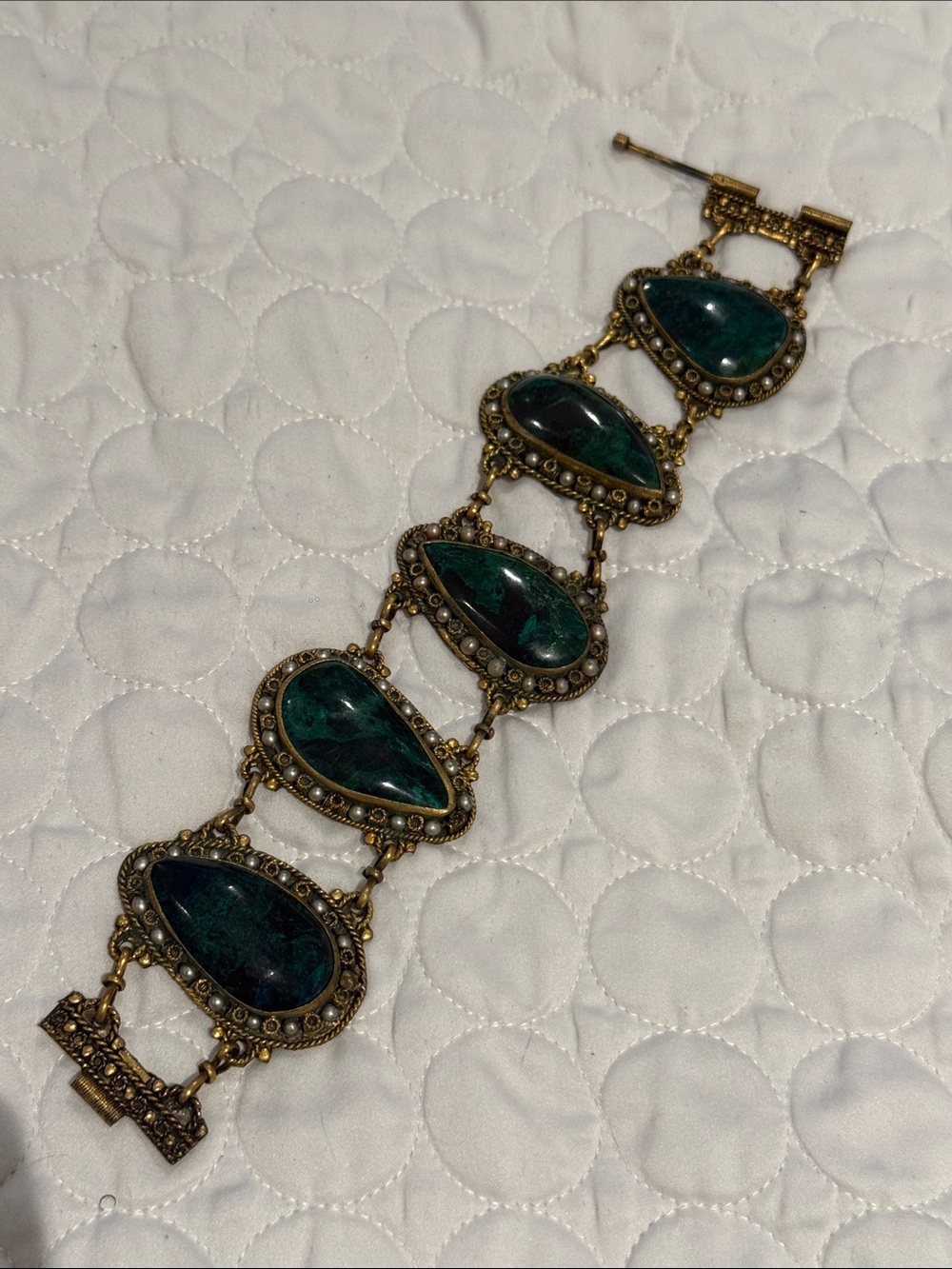 Vintage gold tone panel bracelet featuring dark green faux jade stones